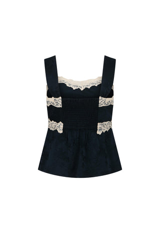 a-dark-navy-blue-velvet-like-smocked-top-with-wide-straps-and-beige-lace-trim-at-the-neckline-and-waist-shown-on-a-plain-white-background