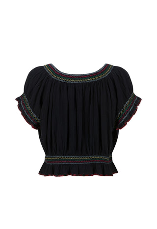 A black short-sleeve blouse with colorful embroidered trim around the neckline and sleeve cuffs, and a smocked ruffled hem, shown against a plain white background.