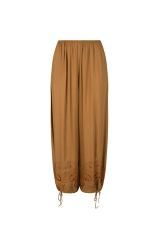 A pair of loose, wide-leg harem-style pants in a warm camel brown color, featuring gathered elastic waistband and drawstring hems with embroidered detailing near the lower legs, shown against a plain white background.