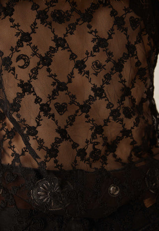 Close-up of a black lace corset top with floral embroidery over sheer mesh, paired with a dark lace belt featuring ornate metal buttons.