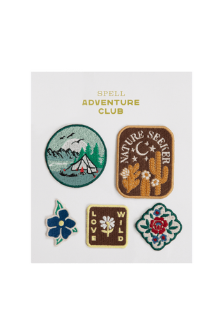 Set of five embroidered patches with nature-themed designs on a white card, featuring the brand 'Spell Adventure Club'.