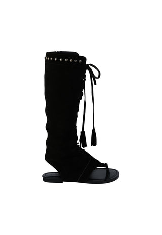 A black knee-high wedge sandal boot with silver studs along the top collar, lace-up front details, and tassel ties, shown against a plain white background.